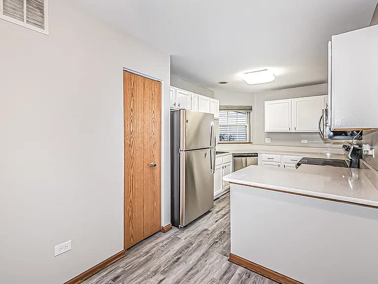 Kitchen with quartz countertops and stainless steel refrigerator