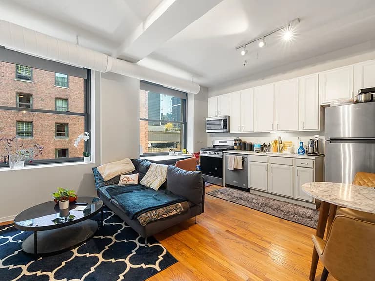 Wide view of the open living room and contemporary kitchen